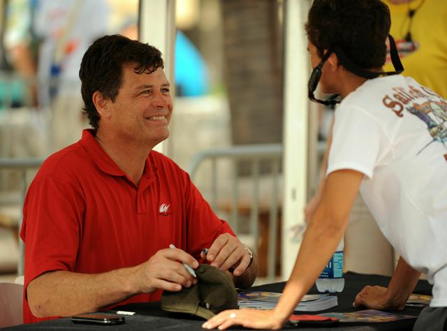 Michael Waltrip signs autographs for fans during the Coca-Cola Fuels NASCAR Championship Drive on Miami Beach on November 18, 2010. Marc Serota / Getty Images for NASCAR